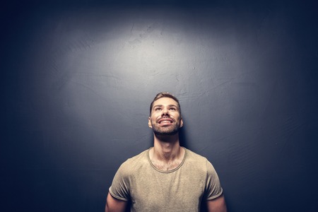 Attractive, smiling man leaning against the wall. Hapiness and positive attitude. Vintage look.の写真素材