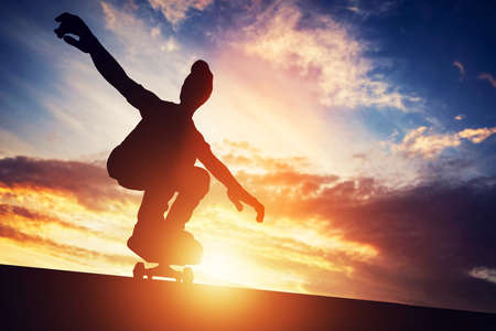 Man skateboarding at sunset. Passion and sport. Idea of freedom and youth. 3d illustration.の写真素材