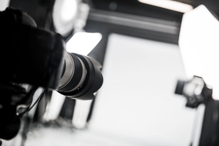 Photo studio with professional lighting equipment. Focus on the camera.