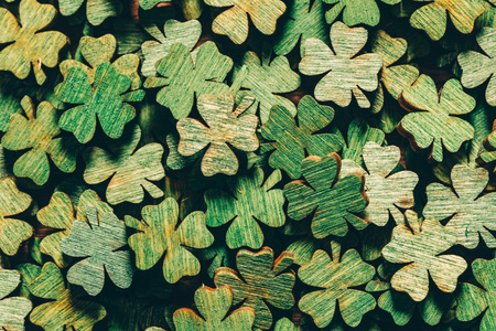 Pile of wooden green four-leaf clovers laying down. Luck symbol. St. Patrick's day.の写真素材