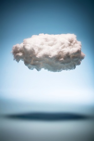 One cloud on a blue background. Weather and digital cloud concept. Cotton handmade.の写真素材