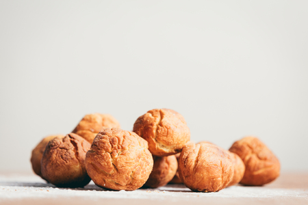 Bunch of baked donuts laying on the kitchen counter. Sweet snack. Homemade goods.の写真素材