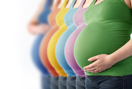 Six pregnant women standing in a row. Expecting mothers. Stem cells and prenatal screening.