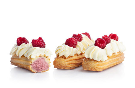 Raspberry eclairs isolated on white background. Tasty french snack.