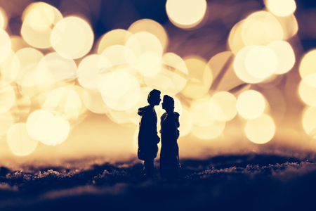 Loving couple standing in a cozy winter scenery. Romantic Christmas scene. Valentine's Day.の写真素材