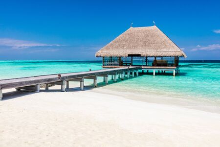 Wooden jetty on blue ocean in Maldives. Popular holiday destinations. Travelling and tourism.の写真素材