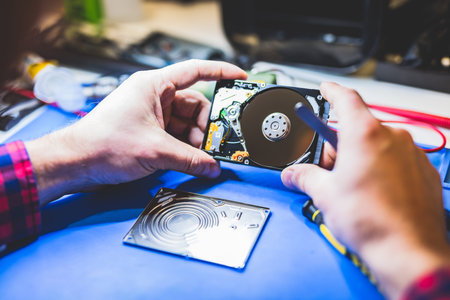Man holding a hard disc. IT hardware. Engineering and technical service.