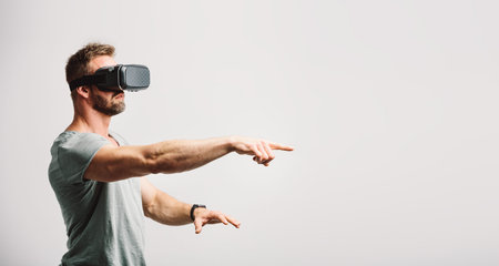 Man using vr headset clicking with finger. Modern technology, virtual reality fun