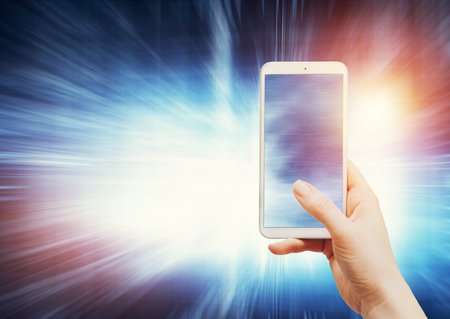 Woman holding a smartphone on modern background. Wireless technology and connection. Internet and...