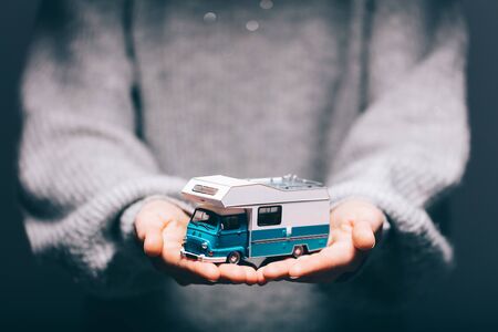 Camper car in woman's hands. Travel, holidays, vacation conceptの写真素材