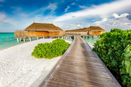 Wooden jetty and cabins on Maldives. Tropical holiday destination. Vacations and travelling.のeditorial素材