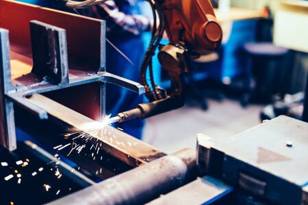 Robotic arm in a factory at work. Modern heavy industry, technology and machine learningの写真素材