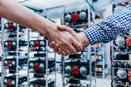 IT business handshake. Having a deal in technology industry, crypto currency and bitcoin mining.の写真素材