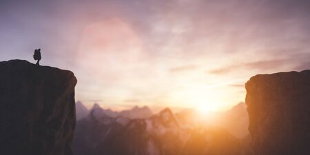 Man on the peak of mountain looking at sunset sky. Trip and adventure. Inspirational. 3D illustrationの写真素材