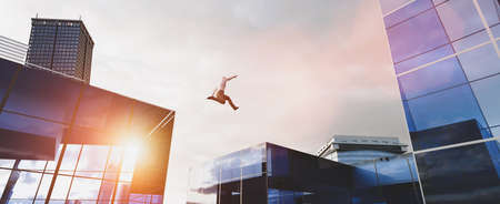 Man jumping between skyscrapers. Concept of business challenge, corporation ambition, success. 3D illustrationの写真素材