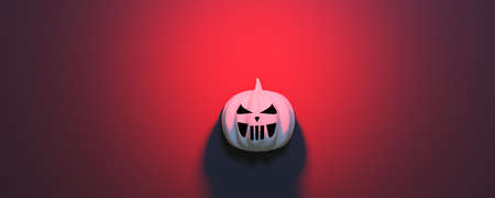 Halloween pumpkin on red background. Jack-o'-lantern scary carved face.の写真素材