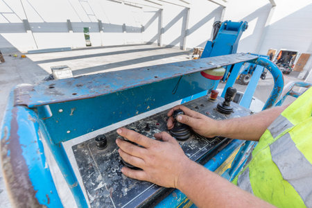 Warehouse construction. Worker operating a mobile elavating work platform