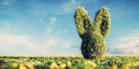Easter bunny made of spring grass and flowers on green meadow. 3D illustrationの写真素材