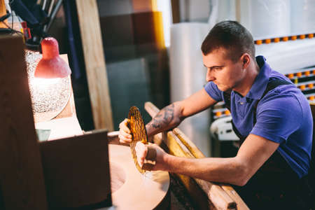 Glazier worker polishing glass in workshop. Industry and manufactory productionの写真素材