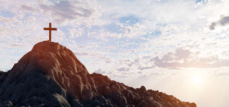 Cross on mountain peak at sunset religion and faith. Christian symbol.の写真素材