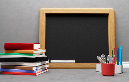 Back to school. Empty blackboard, books and stationery.の写真素材
