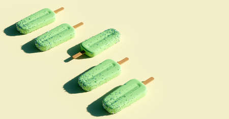 Apple green background. Fruity ice pop, ice cream treatの写真素材