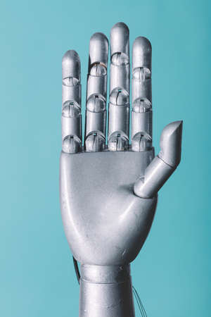 Robotic hand in retro future style on blue backgroundの写真素材