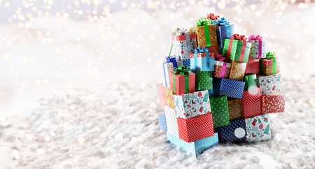 Christmas stack of gifts and presents on snow, glitter lights. 3D illustrationの写真素材