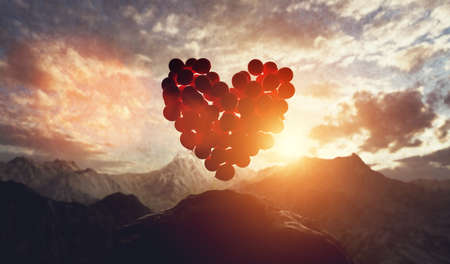 Balloons in heart shape at sunset in mountains. Valentine's day and love concept. 3d illustrationの写真素材