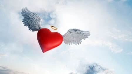 Heart with angel wings and gold ring love symbol flying in clouds. Valentine's day theme. 3D illustrationの写真素材