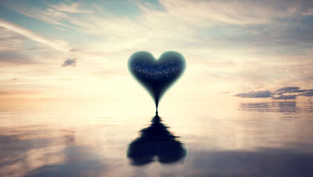 Heart reflection in water at sunset. Valentines day themeの写真素材