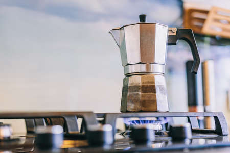 Retro stovetop espresso coffee maker on kitchen gas stoveの写真素材