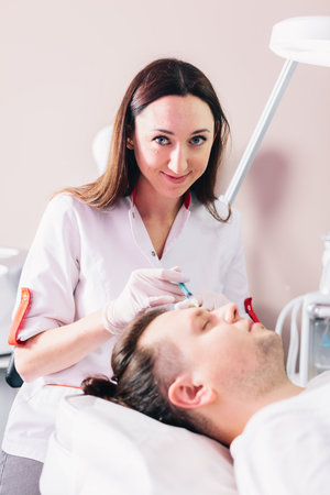 Injectable tissue stimulator on man face in beauty salon. Aesthetic medicineの写真素材
