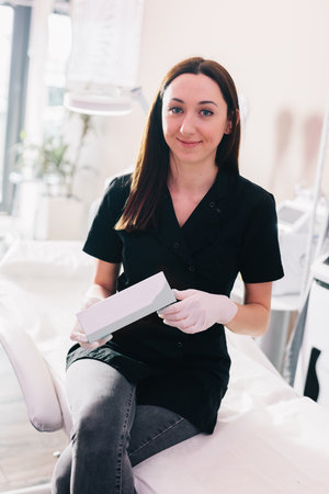 Aesthetic medicine doctor or cosmetologist presenting a product. professional clinicの写真素材