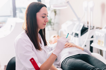Aesthetic medicine doctor preparing syringe for injection in beauty salonの写真素材