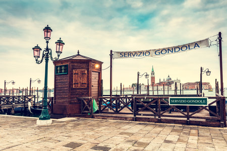 Gondola service in Venice, Italy at sunrise. View on church of San Giorgio Maggioreの写真素材