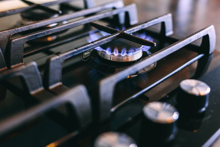 Gas flames burning on kitchen stove top.の写真素材