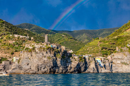 Rainbow over Cinque Terre coast with Vernazza village, Italy