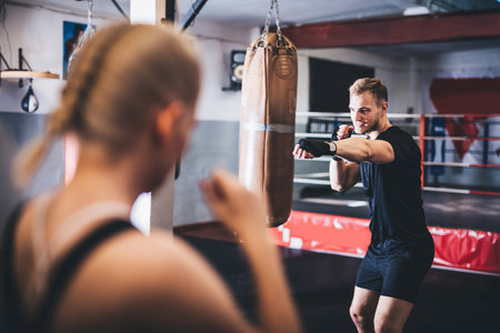 Woman on boxing training with instructor on a gymの写真素材
