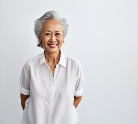 Old senior happy Asian woman isolated on white.の素材