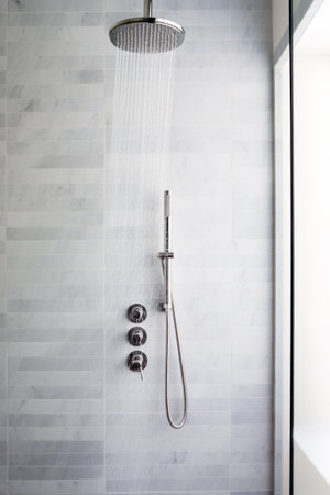 Ceiling mounted rain shower head in modern bathroom.の素材