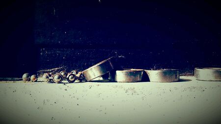 Old used ball bearings on a wall with vintage effect の素材