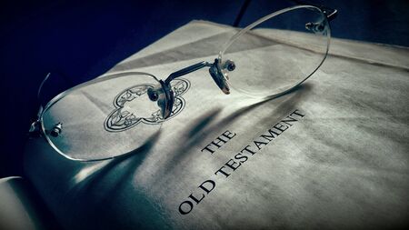 Old holy bible with spectacle and vintage sepia effectの素材