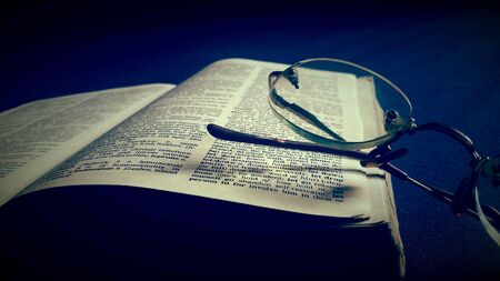 Old holy bible with spectacle and vintage sepia effectの素材