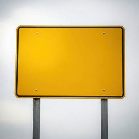 The image depicts a blank yellow road sign mounted on two metal poles against a plain background. The sign is rectangular with four evenly spaced holes around its perimeter.の素材