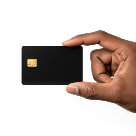 Hand holding a black credit card with gold emblemの素材