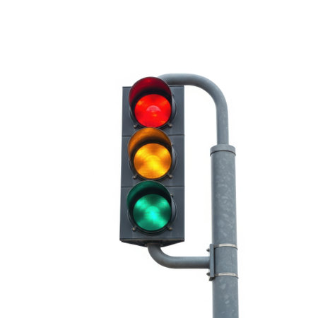 The image shows a traffic signal mounted on a pole, displaying a red light at the top. The signal has three lights: red at the top, yellow in the middle, and green at the bottom. The traffic signal is designed to regulate vehicular and pedestrian traffic at intersections.の素材