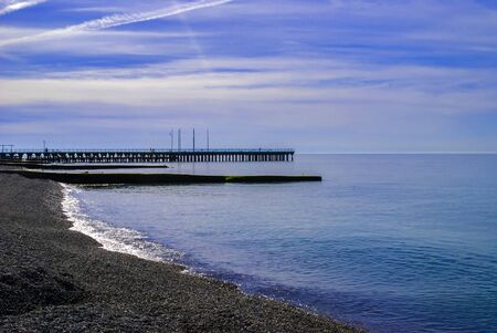 Beautiful day at the beach, gray stones, blue skyの写真素材