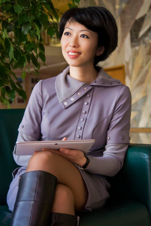 Woman is holding tablet, thinking