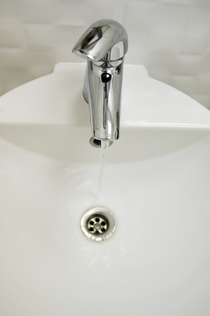 Beautiful view of a white sink, white bathroomの写真素材